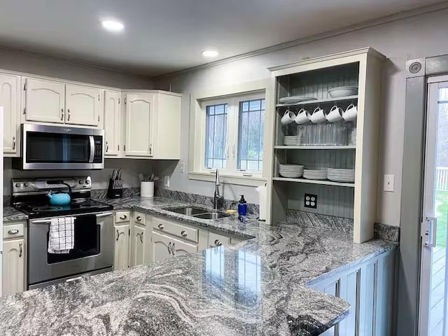 kitchen with white cabinets, appliances with stainless steel finishes, and plenty of natural light