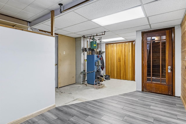 interior space with a paneled ceiling and light hardwood / wood-style flooring