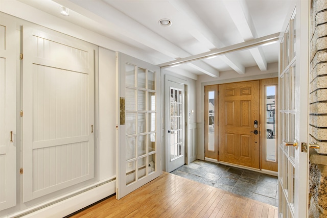 entryway featuring wood-type flooring, french doors, a baseboard heating unit, and beam ceiling