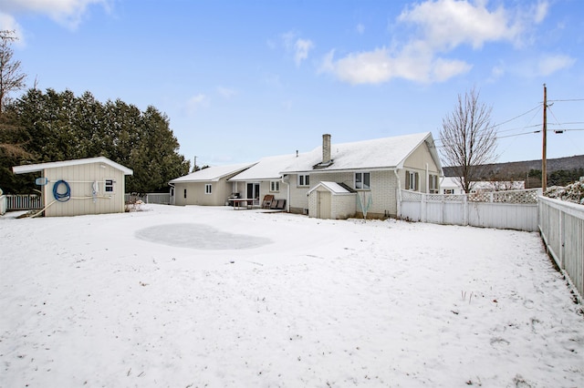 snow covered house with a shed