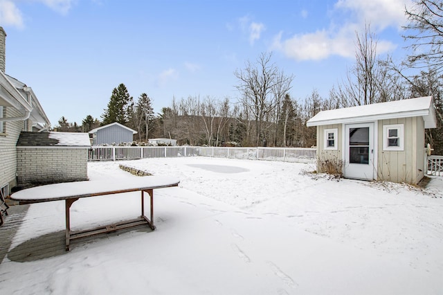 yard covered in snow featuring an outdoor structure