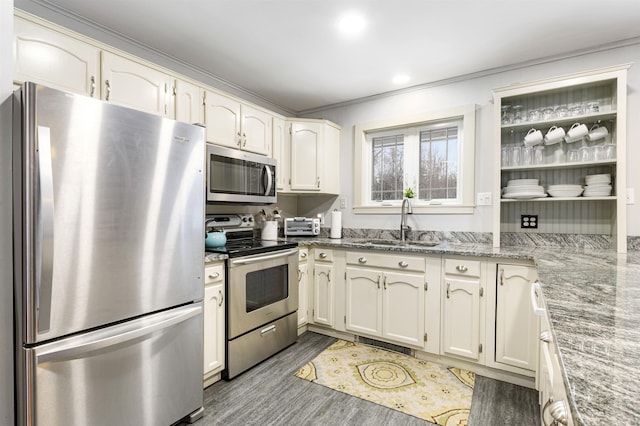 kitchen with light stone countertops, appliances with stainless steel finishes, crown molding, sink, and dark hardwood / wood-style floors