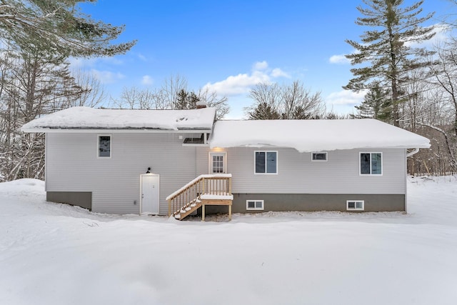 view of snow covered back of property