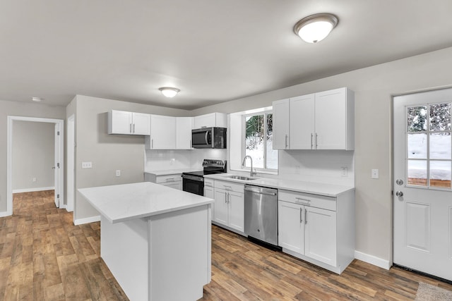 kitchen featuring white cabinets, a center island, and stainless steel appliances