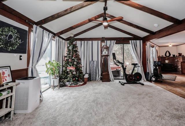 workout area featuring carpet flooring, ceiling fan, and vaulted ceiling