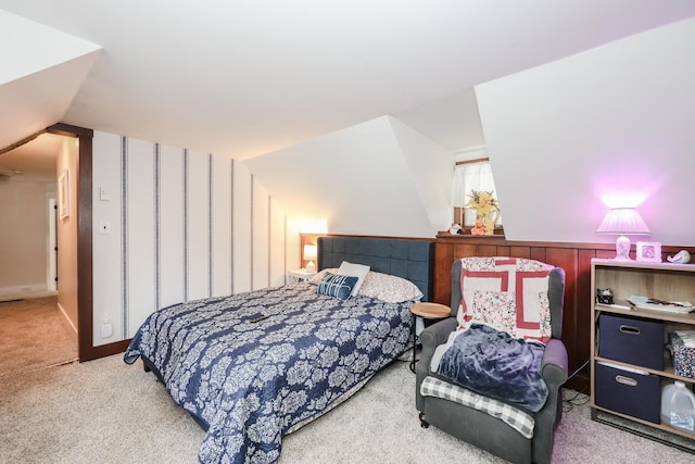 bedroom with carpet floors and vaulted ceiling