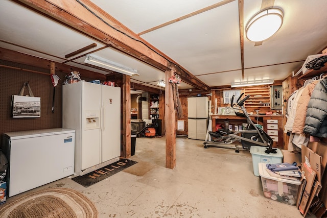 basement with electric panel, white fridge with ice dispenser, refrigerator, and white fridge