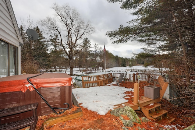 snow covered deck featuring a hot tub