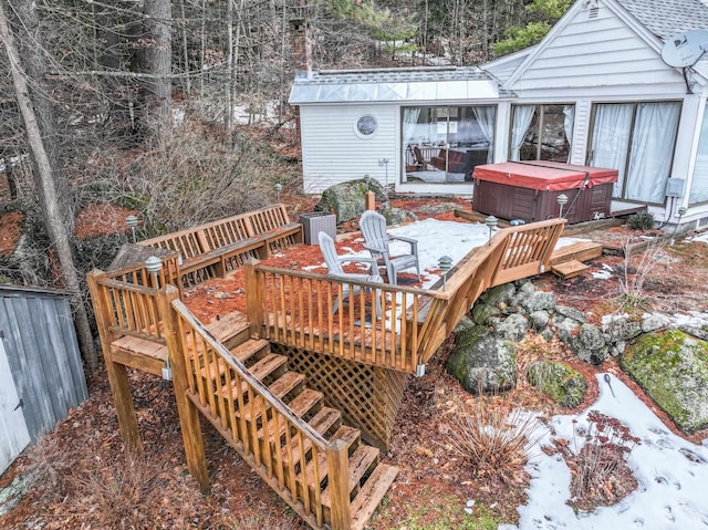 wooden terrace featuring a hot tub