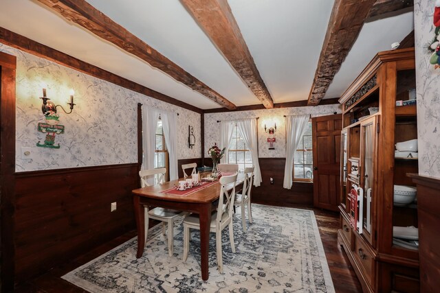 dining area with beamed ceiling and dark hardwood / wood-style floors