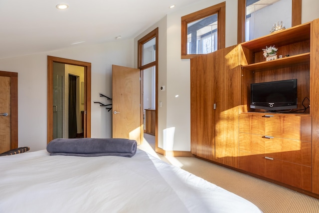 carpeted bedroom with lofted ceiling