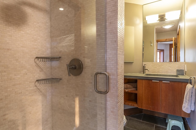 bathroom featuring vanity, tasteful backsplash, tile patterned floors, and walk in shower