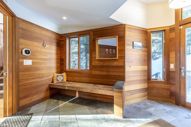 mudroom featuring wood walls