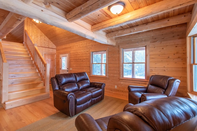 living area featuring wooden ceiling, light wood-style flooring, stairway, wood walls, and beam ceiling