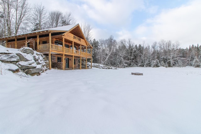 snow covered property with a deck