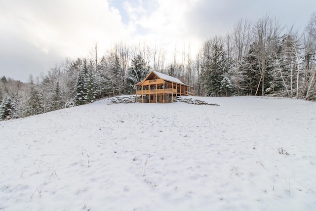 yard covered in snow featuring a wooden deck