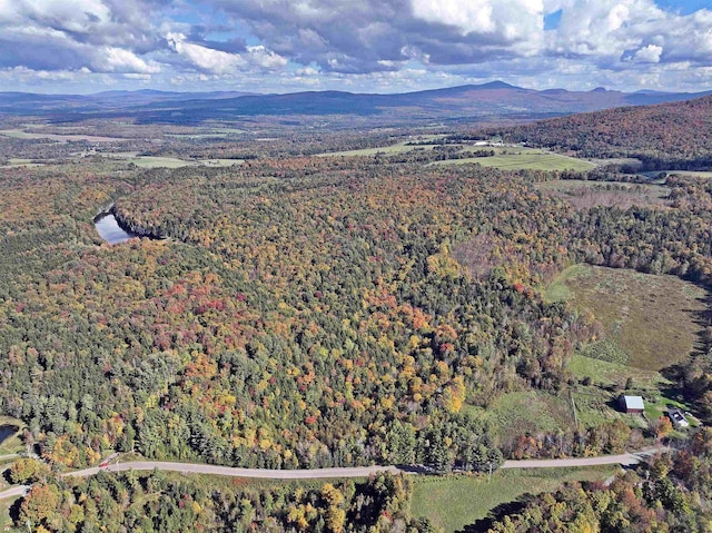 aerial view with a mountain view and a view of trees