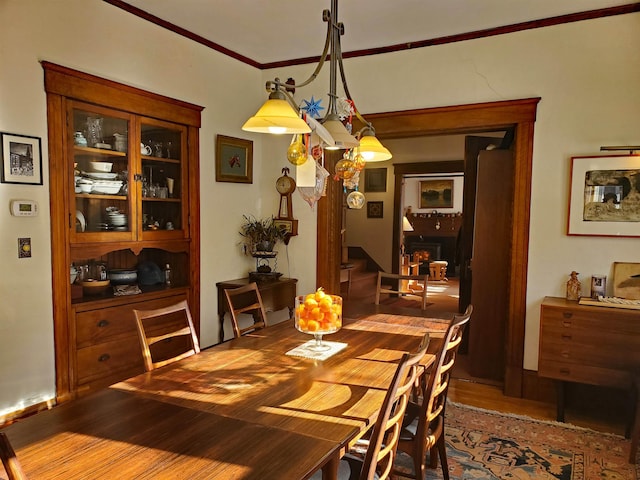 dining room with ornamental molding and hardwood / wood-style flooring