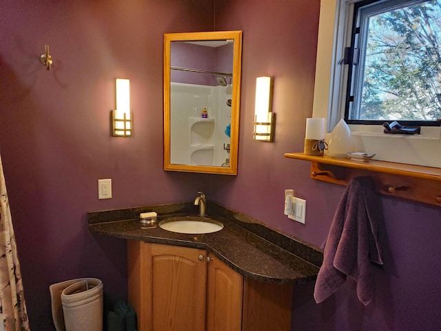 bathroom featuring a shower with shower curtain and vanity