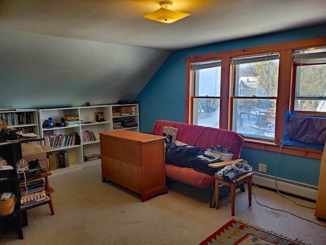 interior space featuring lofted ceiling, carpet floors, and a baseboard heating unit