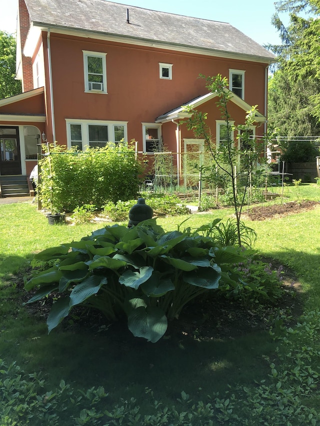 back of property featuring a lawn