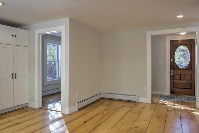 entrance foyer featuring light hardwood / wood-style flooring and a baseboard radiator