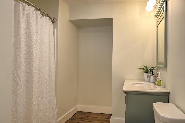 bathroom featuring vanity, hardwood / wood-style flooring, and toilet