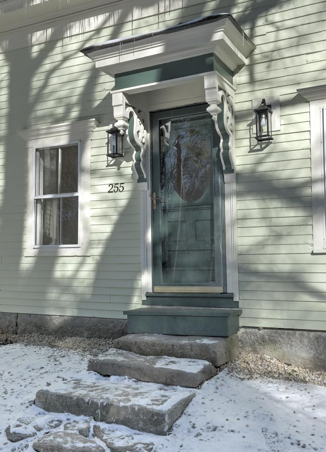 view of snow covered property entrance