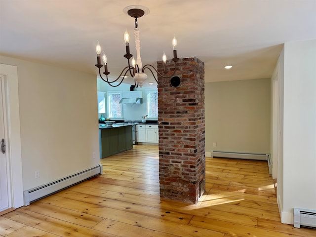 interior space featuring a baseboard radiator, a chandelier, and light hardwood / wood-style flooring