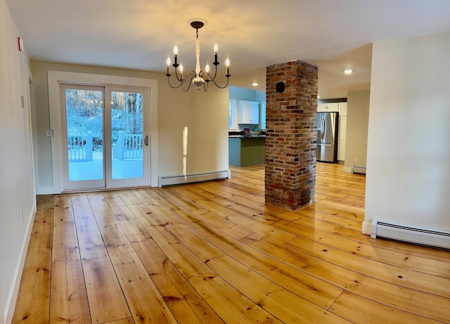 interior space with baseboard heating and light hardwood / wood-style floors