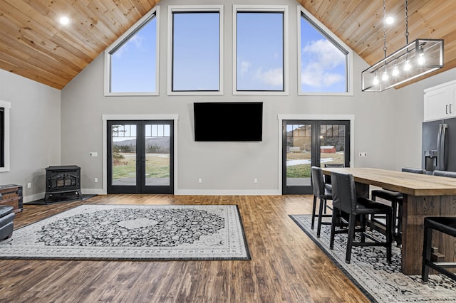 living room featuring a wood stove, french doors, wooden ceiling, high vaulted ceiling, and hardwood / wood-style floors