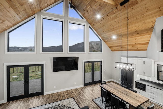 living room with dark hardwood / wood-style flooring, french doors, wood ceiling, and an inviting chandelier