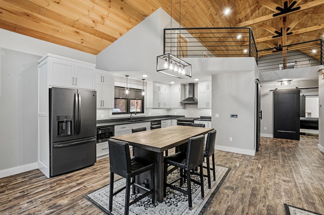 kitchen with white cabinets, stainless steel fridge with ice dispenser, high vaulted ceiling, and wall chimney range hood