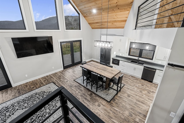 interior space featuring wooden ceiling, high vaulted ceiling, french doors, sink, and hardwood / wood-style flooring