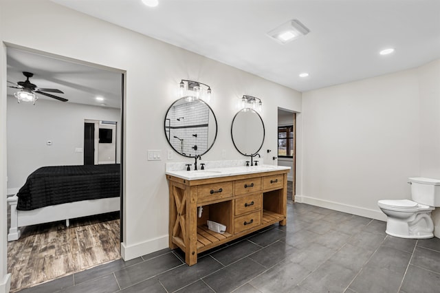 bathroom with vanity, toilet, and ceiling fan