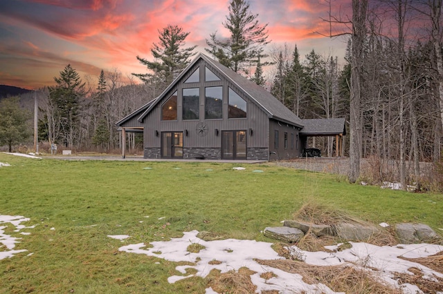 back house at dusk with a yard