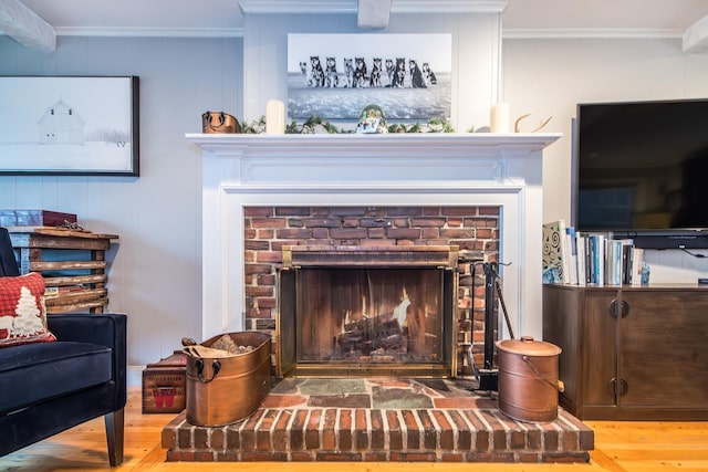 details featuring a brick fireplace, crown molding, and hardwood / wood-style flooring