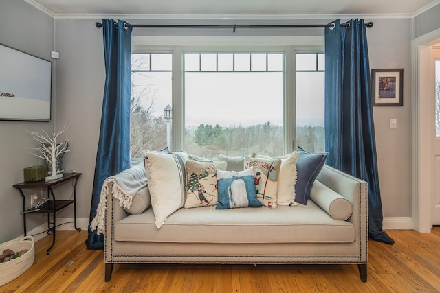 sitting room with crown molding and hardwood / wood-style floors