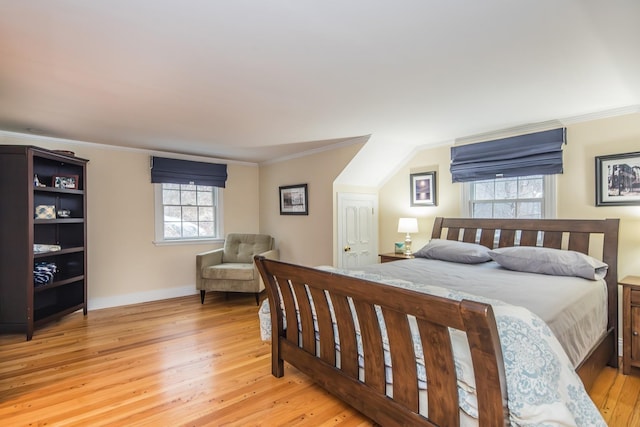 bedroom with crown molding and light hardwood / wood-style floors