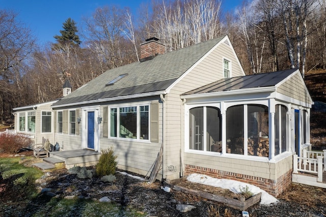 back of house with a sunroom