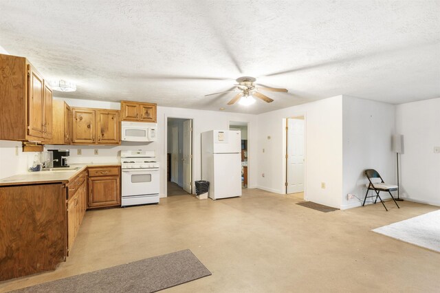 kitchen with a textured ceiling, ceiling fan, sink, and white appliances