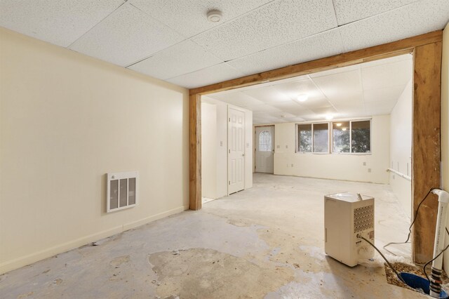 unfurnished room featuring a drop ceiling and concrete flooring