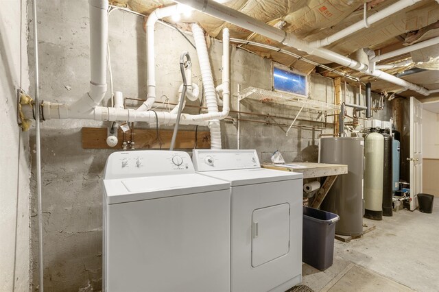 laundry area with washing machine and dryer and gas water heater