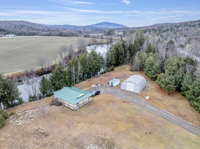 drone / aerial view featuring a water and mountain view