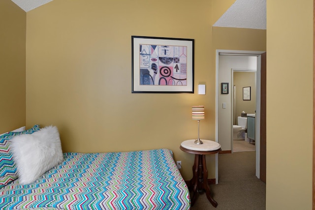 bedroom with vaulted ceiling, carpet floors, and a textured ceiling