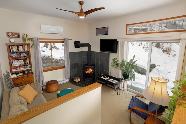 interior space with carpet, a wood stove, a baseboard heating unit, an AC wall unit, and ceiling fan