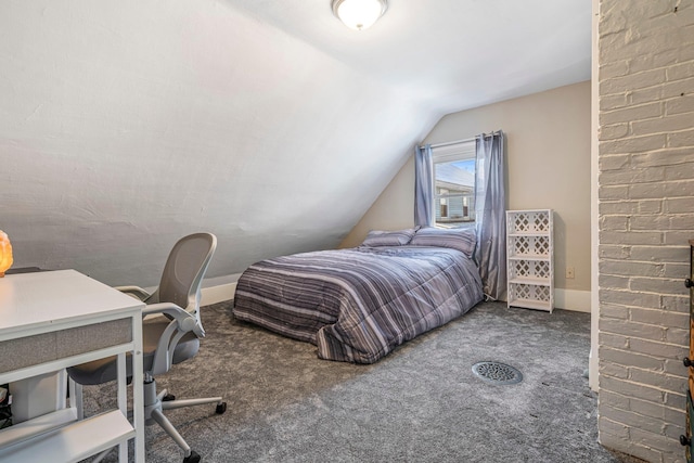 bedroom featuring dark colored carpet and lofted ceiling