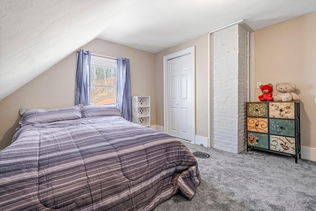 bedroom featuring lofted ceiling, carpet floors, and a closet