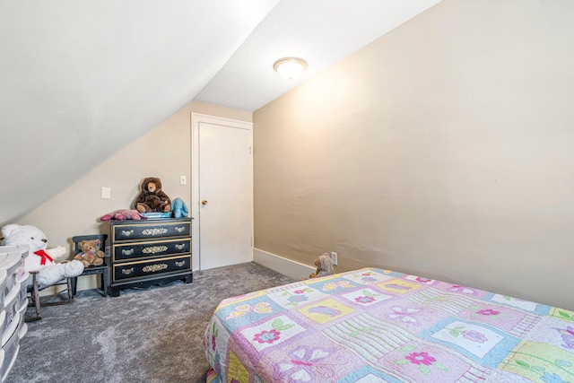 bedroom with lofted ceiling and dark colored carpet