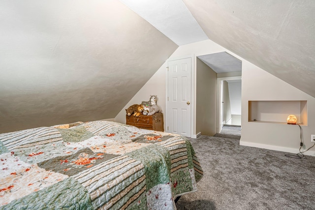 carpeted bedroom with a textured ceiling and vaulted ceiling